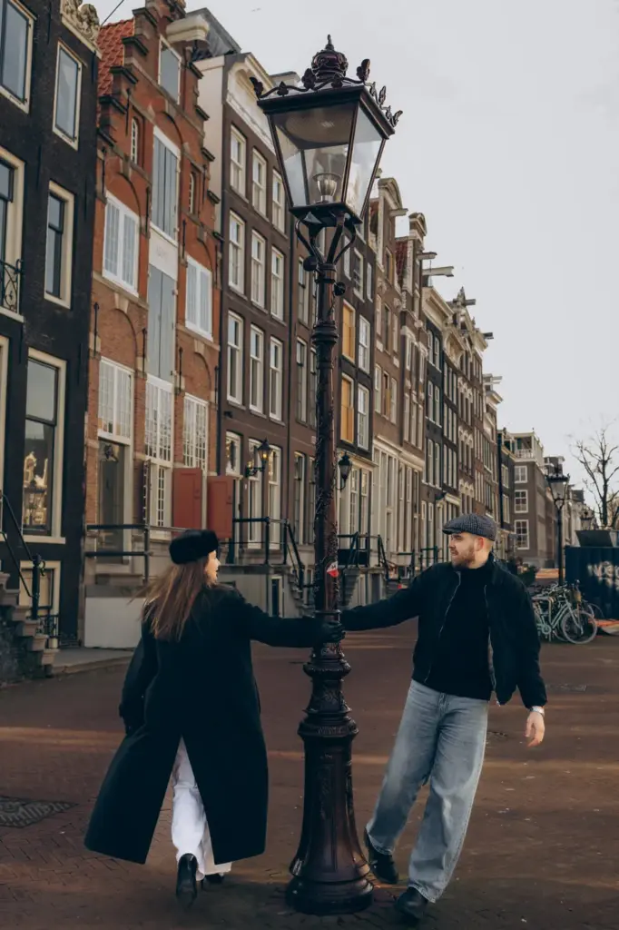 Couple dancing around a street lamp on an Amsterdam canal street