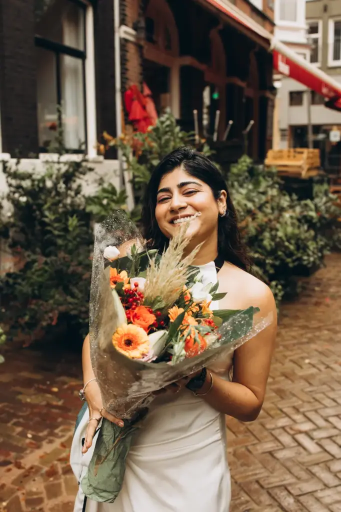 Woman smiling with a bouquet of flowers after the proposal